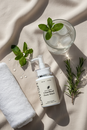 ClearBeard Face Wash bottle with a glass of water and mint leaves on a beige fabric background