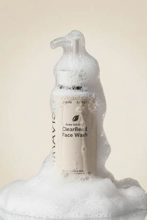 Bottle of ClearBeard Face Wash with foam on a beige background