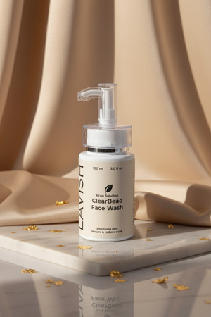 ClearBeast face wash bottle on a reflective surface with a beige curtain background
