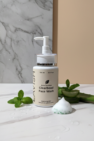ClearBead Face Wash bottle with green leaves on a marble surface