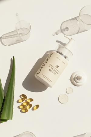 Lavish Skin product with capsules and aloe vera leaves on a light background