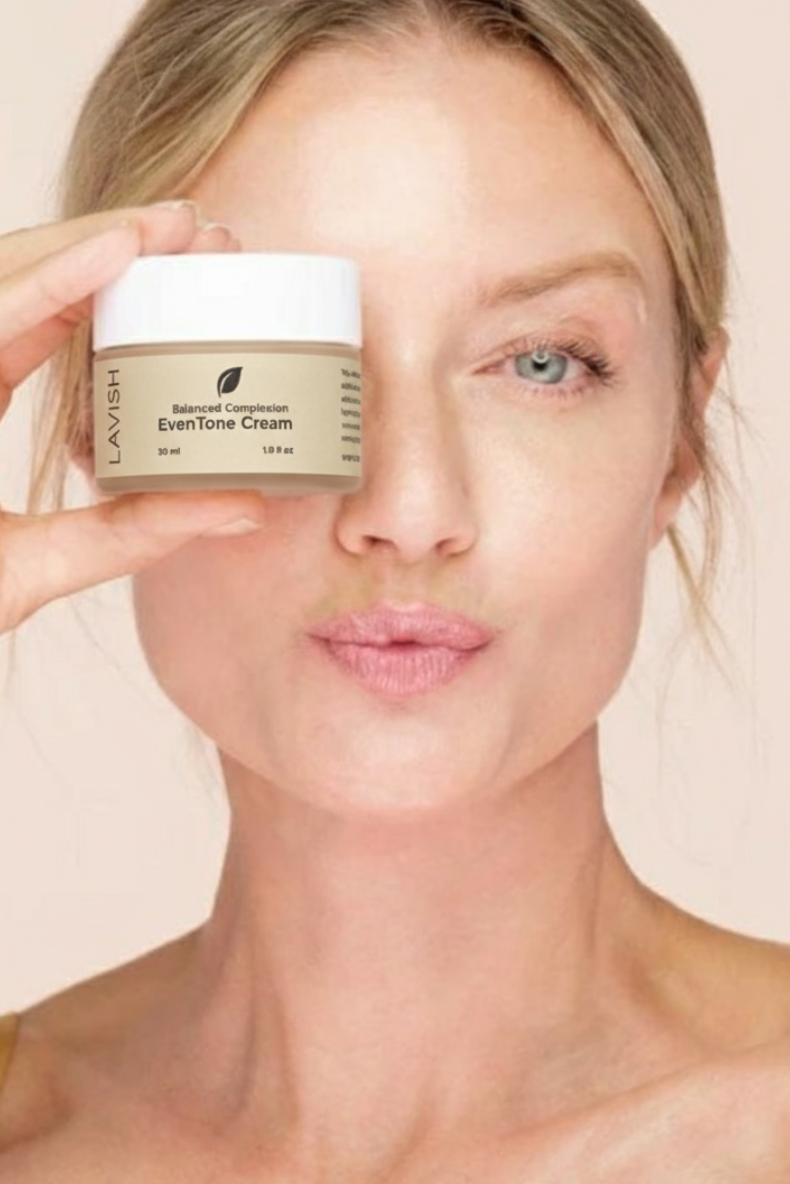 Woman holding a jar of Lavera EvenTone Cream against a beige background