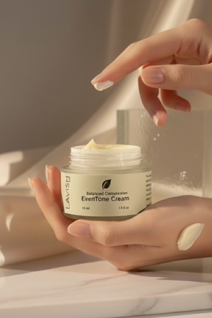Person holding a jar of Lavish EverTone Cream with a swatch on their hand.