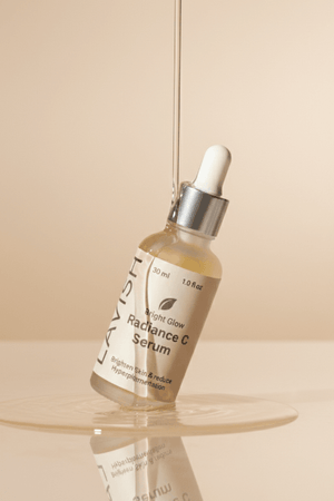 Radiance C Serum bottle with dropper on a beige background